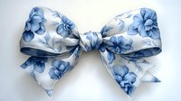 Elegant fabric bow with delicate blue floral pattern on white background, featuring graceful curves and soft folds for decorative and fashion applications.