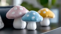 Colorful spotted mushroom decorations in pastel pink and blue with polka dot caps on white stems, arranged in a whimsical display for nursery or home decor.