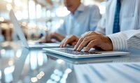 Close up of business professional hands typing on wireless keyboard at modern office desk with blurred background and soft lighting effects.