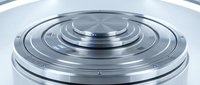 Metallic circular platform with concentric rings and chrome finish for futuristic technology and industrial design concepts.