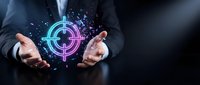 Businessman in dark suit holding glowing neon cryptocurrency symbol with digital particles, representing blockchain technology and digital finance innovation.