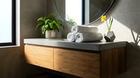 Modern floating bathroom vanity with wooden drawers, round mirror, and spa accessories in contemporary interior design for home renovation projects.