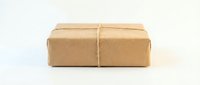 Brown kraft paper package tied with natural twine string isolated on white background for shipping and delivery services.