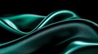 Luxurious emerald green silk fabric with soft waves and folds creating elegant curves and shadows against dark background, smooth textile surface with satin sheen.