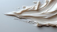 Smooth flowing white cream texture with elegant swirls and ripples creating abstract organic shapes against light background, luxury cosmetic product background.