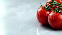 Fresh ripe red tomatoes on vine with water drops against light background, macro food photography showing natural texture and freshness.