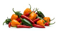Colorful assortment of fresh hot chili peppers including orange habaneros, red cayenne, and green jalapenos isolated on white background for cooking and spice concepts.
