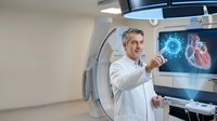 Middle-aged Caucasian male doctor in white coat pointing at holographic heart display in modern medical facility for healthcare technology presentations.