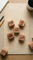 Wooden business concept stamps with corporate symbols on desk workspace with coffee and pencils for office branding and marketing materials.