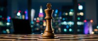 Golden chess queen piece standing on board with blurred city lights in background, representing strategy, leadership, and business success for corporate and game-related projects.