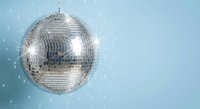 Shiny silver disco ball with sparkling reflections on light blue background for party and nightclub entertainment events.
