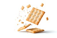 Floating broken salty crackers with crumbs isolated on white background. Dynamic food composition showing snack pieces in motion.