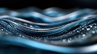 Macro photography of flowing water with sparkling droplets and waves creating dynamic curves in blue tones against dark background. Artistic nature abstract.