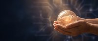 Hands holding glowing golden sphere with light rays on dark background, representing innovation, technology, energy, and future solutions for business concepts.