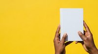 Hands holding blank white card against bright yellow background for marketing and advertising campaigns.