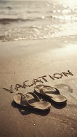 Flip flops on sunny beach sand with word vacation written nearby, ocean waves in background, warm golden light, summer travel mood.