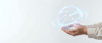 Businessperson holding glowing digital globe hologram, representing global connectivity, technology innovation, and worldwide business expansion on isolated white background.