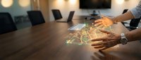 Business professional analyzing holographic financial data and charts on conference table in modern office meeting room.
