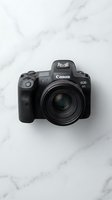 Professional mirrorless camera with black body and lens isolated on white marble background, suitable for photography equipment catalogs, tech reviews, and digital content creation marketing.