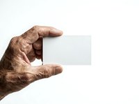 Aged male hand holding blank white business card isolated on white background, suitable for corporate branding and professional mockup designs.