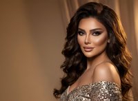 Glamorous Middle Eastern woman with long wavy hair wearing sequined dress in warm studio lighting for luxury fashion and beauty concepts.