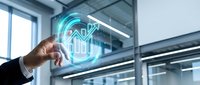 Businessman touching holographic house icon with upward arrow in modern office space representing real estate growth and property investment technology.