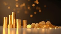 Golden stacks of coins and scattered cryptocurrency on reflective surface with warm bokeh background, symbolizing wealth and financial investment.