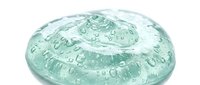 Transparent gel dome with water droplets, isolated on white background, ready for cosmetic, skincare, and beauty product design applications.
