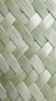 Natural woven bamboo texture with diagonal basket weave pattern. Eco-friendly organic material background for sustainable design projects and tropical decor.