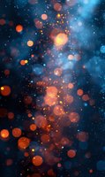 Magical glowing orange and blue bokeh lights on dark background create dreamy atmosphere for festive designs and holiday backgrounds.