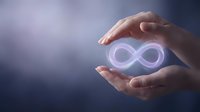 Hands holding a glowing infinity symbol with soft purple light, representing eternity, limitless potential, and endless possibilities in life and business.