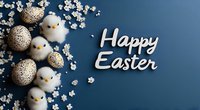 Festive Easter composition with decorative golden speckled eggs, white fluffy toy chicks and cherry blossom branches on dark blue background with holiday greeting text.