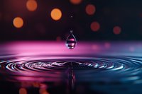 Water droplet creating ripples on colorful surface with bokeh lights background for abstract nature and liquid motion concepts.