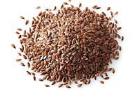 Brown flax seeds pile isolated on white background, macro view of healthy organic linseeds rich in omega-3 fatty acids and dietary fiber for nutrition.