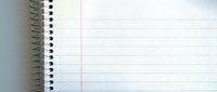Open spiral notebook with blank lined pages ready for writing notes, journaling, or creative projects in office or school setting.