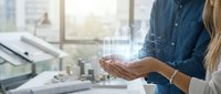 Professional businesswoman and businessman collaborating with holographic data visualization technology in modern office environment for digital transformation.