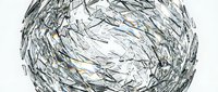 Shattered glass sphere with sharp fragments and cracks creating abstract geometric patterns on white background for modern design projects.