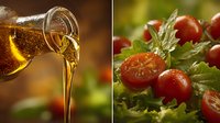 Golden olive oil pouring from glass bottle and fresh cherry tomatoes with green herbs on salad leaves, Mediterranean cuisine ingredients.