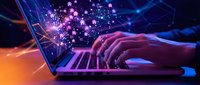 Hands typing on laptop with glowing digital particles and network connections emerging from screen in futuristic cyberpunk style for technology concepts.