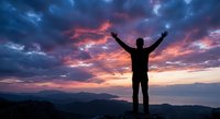Male hiker silhouette celebrating success on mountain peak at dramatic sunset with colorful sky and clouds. Achievement, freedom, adventure concept.