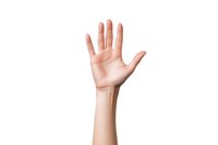 Raised female hand showing palm gesture against white background, isolated cutout for design and commercial use. Clean professional studio lighting.