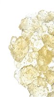 Translucent golden and clear ice cubes with water droplets clustered together on white background, suitable for beverage, refreshment, and cooling product advertising.