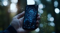 Smartphone displaying glowing blue network visualization against blurred bokeh background, held in hand at dusk, representing digital connectivity and data networks.