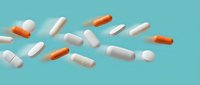 Various pharmaceutical capsules and pills scattered on turquoise background for medical healthcare design projects.