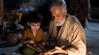 Elderly grandfather with white beard teaching young boy to read from ancient book in warm candlelit setting. Intergenerational bonding and education concept.