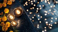 Glowing candles with yellow chrysanthemum flowers on dark surface against blurred bokeh lights create cozy autumn atmosphere. Perfect for seasonal decor and wellness.