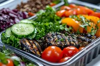 Healthy meal prep container with grilled chicken, fresh vegetables, quinoa and mixed greens ready for balanced nutrition and convenient eating.