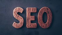 Wooden SEO letters on dark background for digital marketing and search engine optimization concepts in business presentations.
