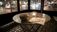 Rainy night cafe scene with coffee cup, candle, and sorry note on rustic table by window, evoking loneliness, regret, and emotional atmosphere.