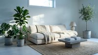Modern living room with light gray upholstered sofa, throw blankets, potted plants, and natural sunlight for home decor and interior design projects.